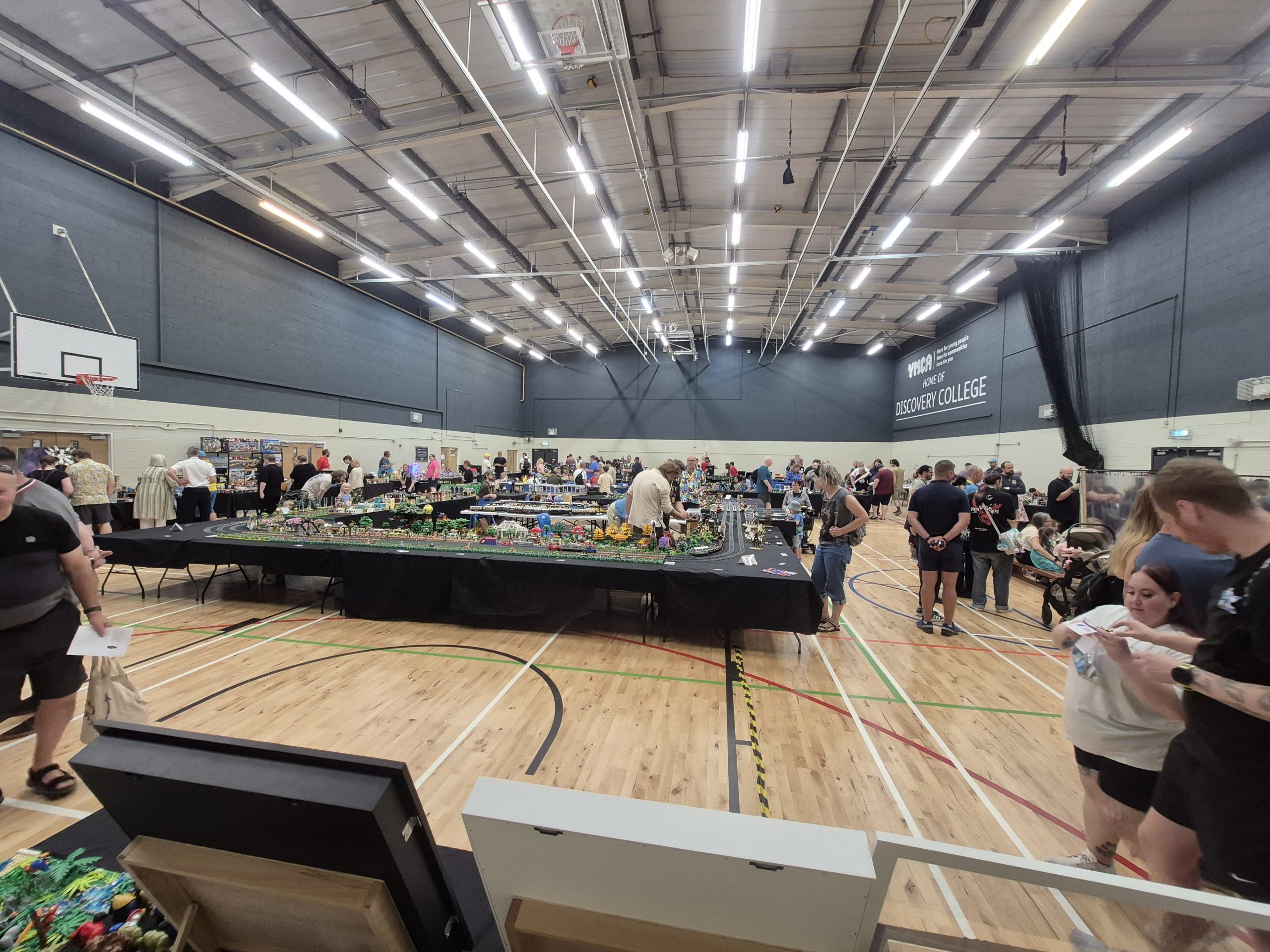 Wide view of the Plymouth Bricktacular show hall, packed with LEGO displays and visitors